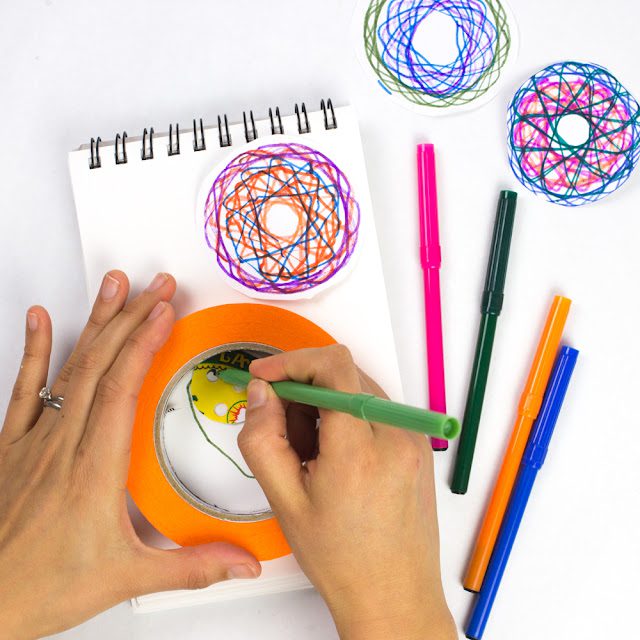 hands working a DIY spirograph Pi Day Activities