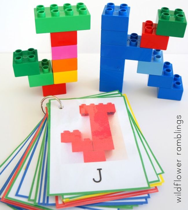 The letters J and K built from LEGO bricks, with a stack of cards