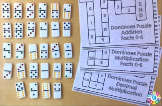 dominos on a table with a page of domino puzzles, math facts games 