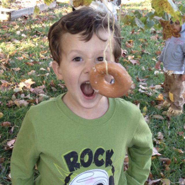 Minute to win it games include eating a donut hanging from a string like the little boy pictured here.