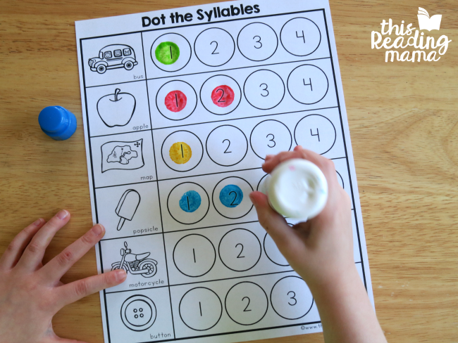 Dot marker creating marks to indicate how many syllables there are in words with their corresponding picture 