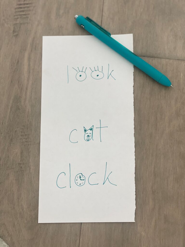 Sight words written on paper with drawings inside the letters, including look with eyes in the o's, cat with a cat face in the a and clock with a clock face in the o.