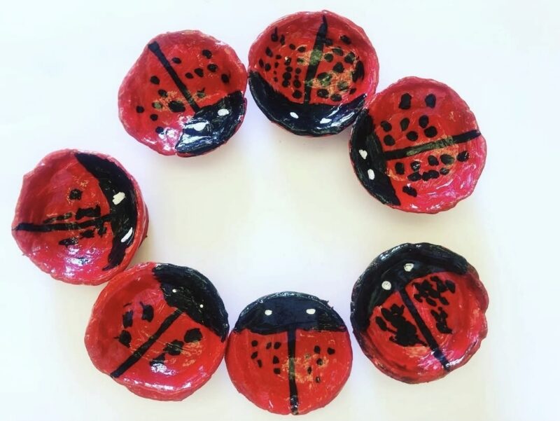 Small clay dishes painted to look like ladybugs