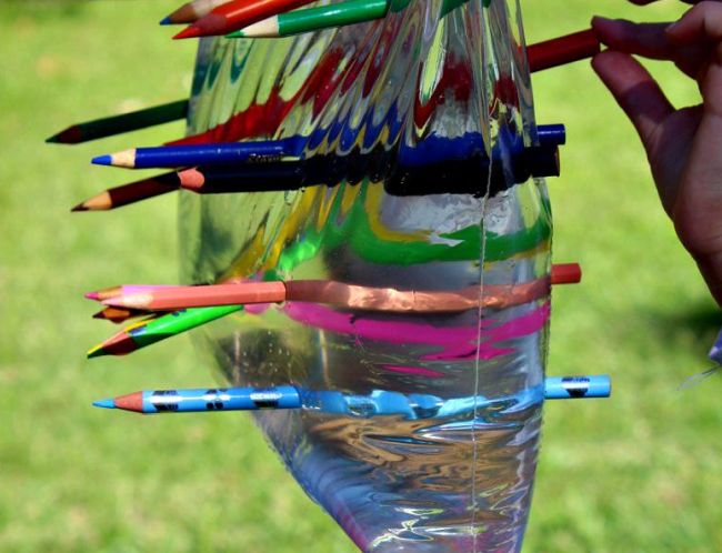 Plastic bag full of water with pencils stuck through it