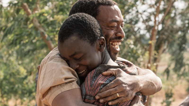 Two characters embracing, from the movie The Boy Who Harnessed the Wind