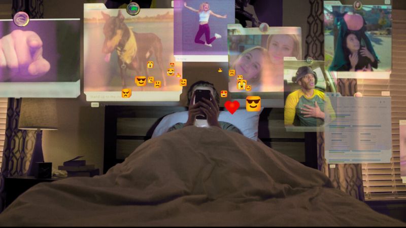 Teen lying in bed looking at a phone, with a collage of images above their head