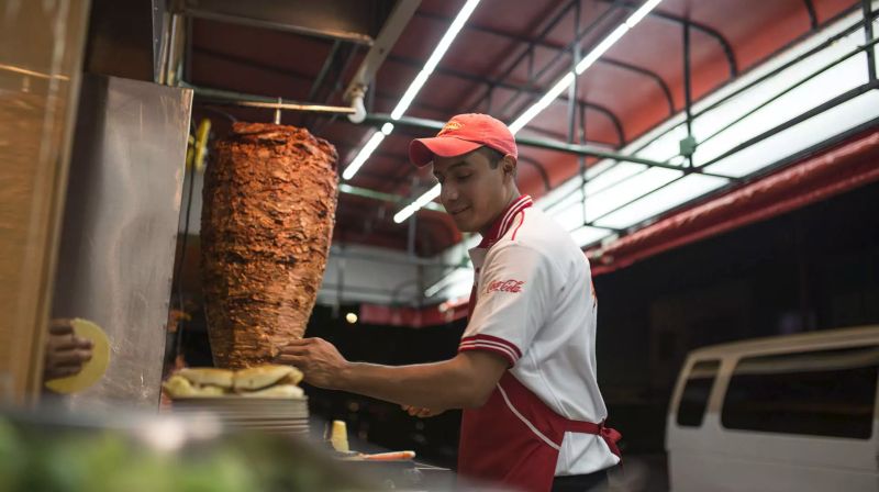 Man preparing Tacos al Pastor for Netflix series Taco Chronicles