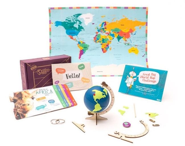 Array of geography learning items including a small globe from KiwiCo Atlas Crate- educational subscription boxes