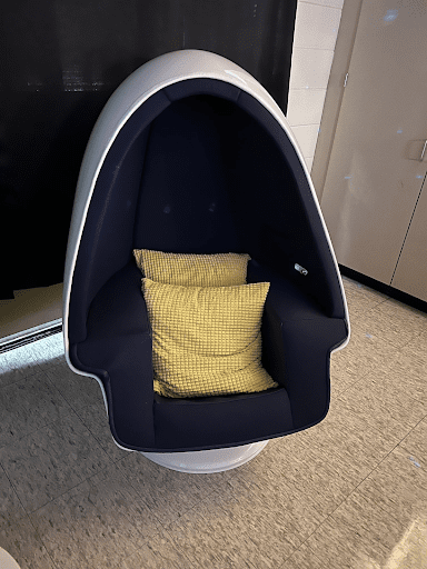Egg chair with yellow pillows, , as an example of sensory room ideas
