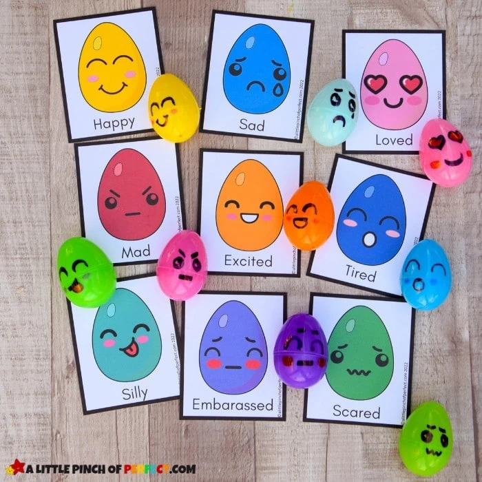 cards have pictures of eggs on them with different emotions. Plastic eggs have matching faces drawn on them.