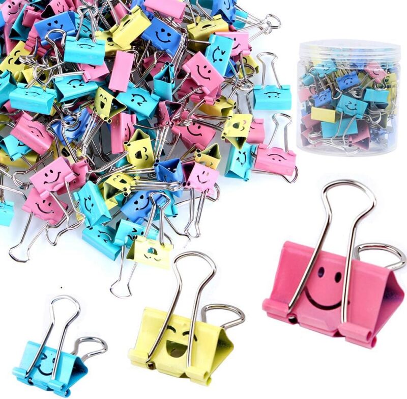 Binder clips in pastel colors with a variety of emoji-style faces