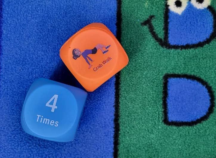 Two exercise dice on classroom carpet, as an example of gross motor activities.