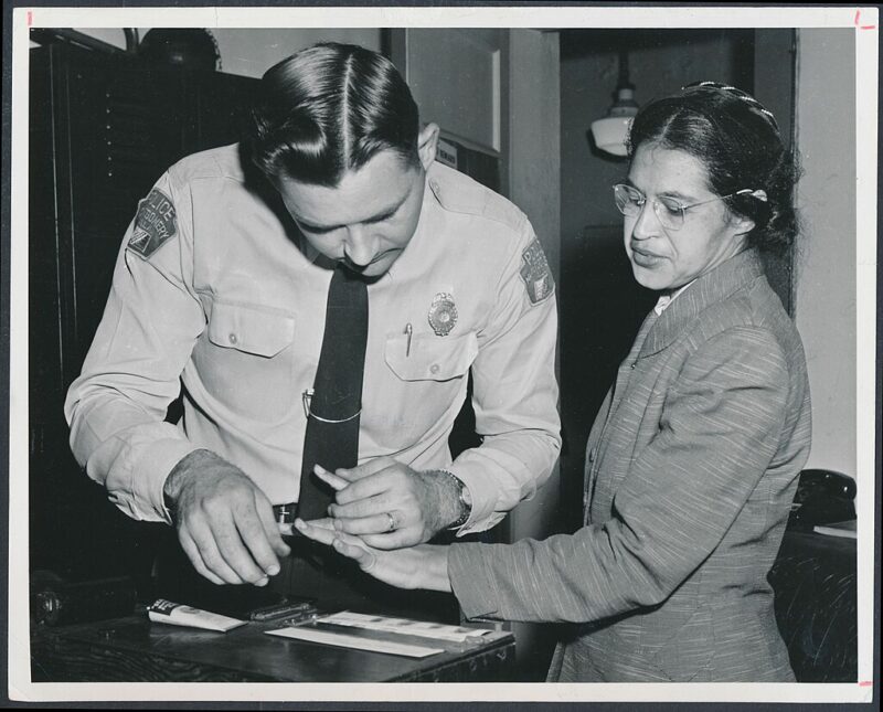 Rosa Parks being booked after being arrested, an example of famous Black Americans everyone should know