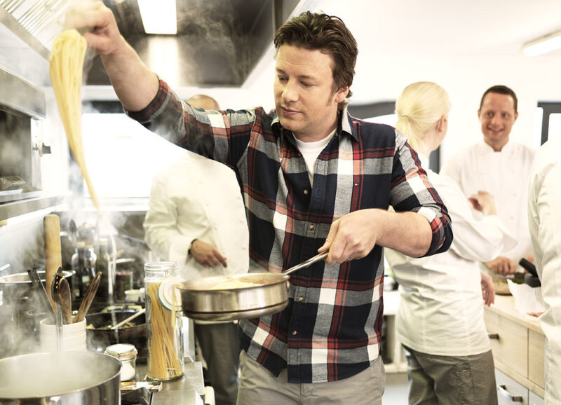 Jamie Oliver making pasta in a kitchen