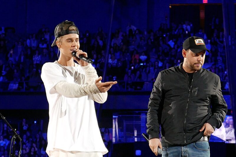 Justin Bieber on stage with Scooter Braun