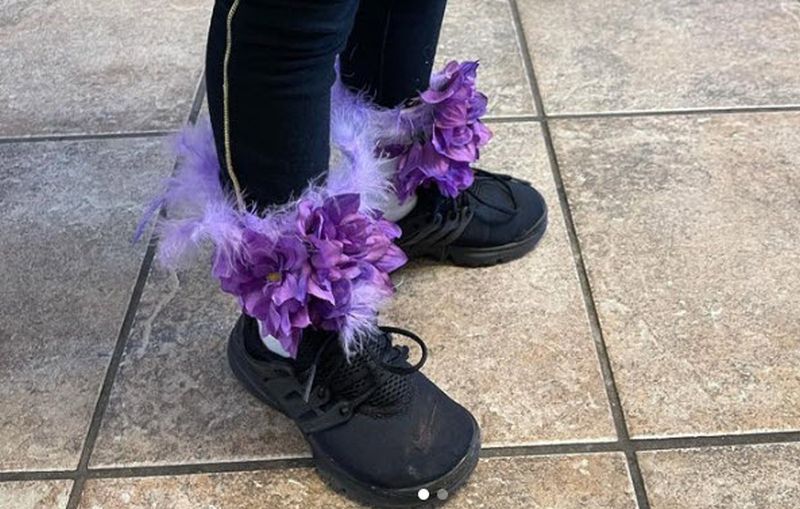 Socks with purple feather boa and fake flowers attached