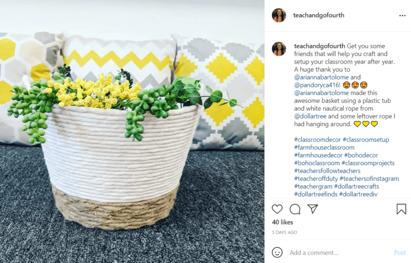 Green and yellow plants fill a small planter decorated with rope with white, grey, and yellow pillows in the background.