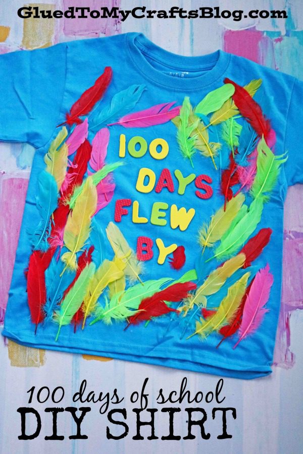 A teal shirt has brightly colored feathers glued to it and stickers that read 100 Days Flew By (100th day of school shirt ideas)