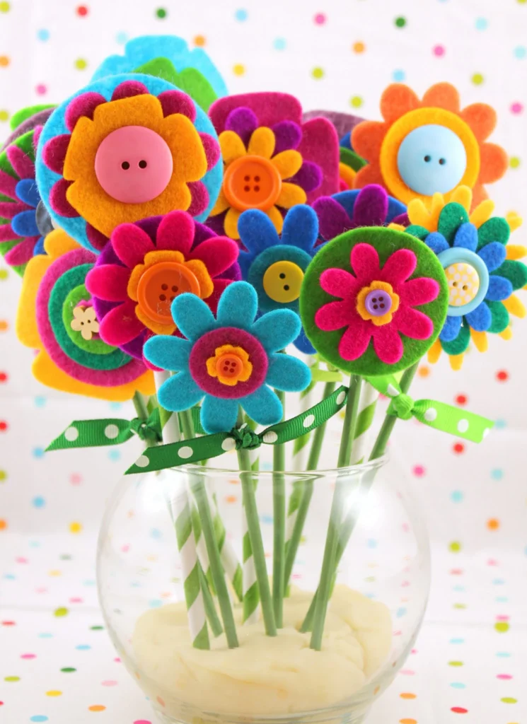 Colorful flowers made from felt peek out of a vase