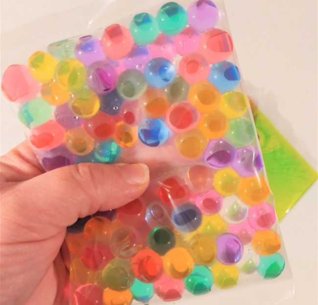 Fidgets for kids: Sealed plastic bag filled with water beads in bright colors