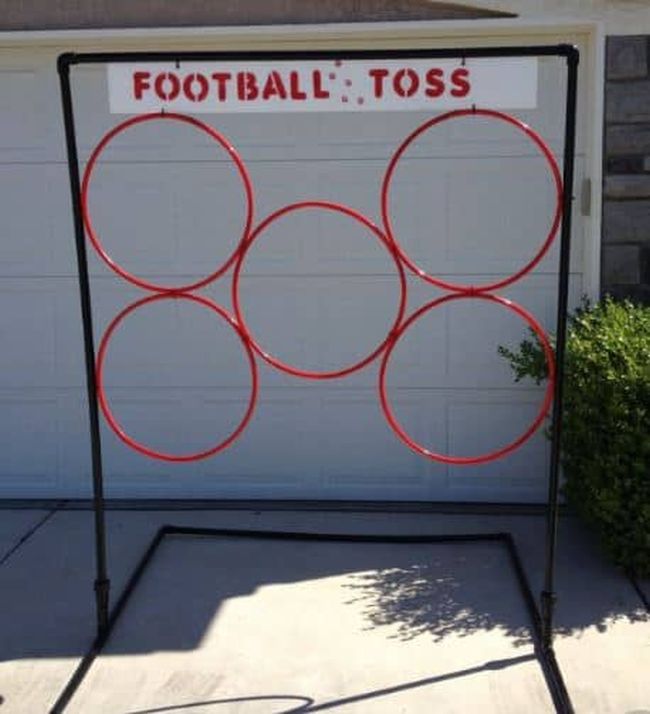 Hula hoops suspended from poles and labeled Football Toss (Field Day Games)