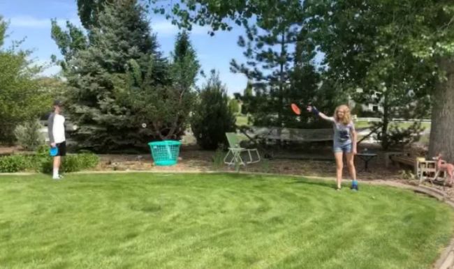 Kids playing Frisbee golf with laundry baskets set on tomato cages