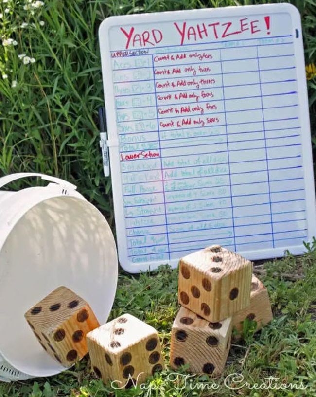 Giant wooden dice and a whiteboard labeled Yard Yahtzee (Field Day Games)