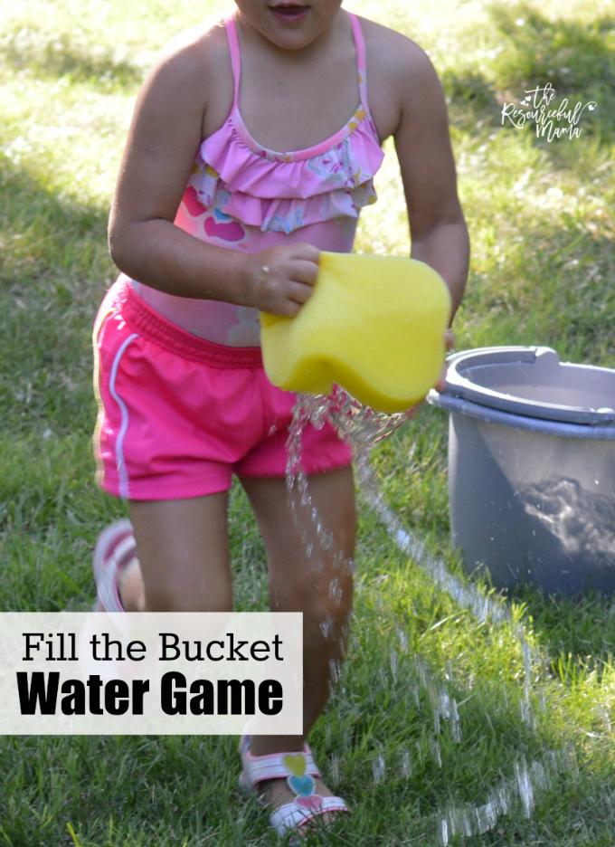girl running with a sponge for a water activity