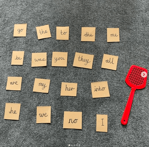 Sight word cards laid out in a grid pattern with a red fly swatter as an example of sight word activities for the classroom