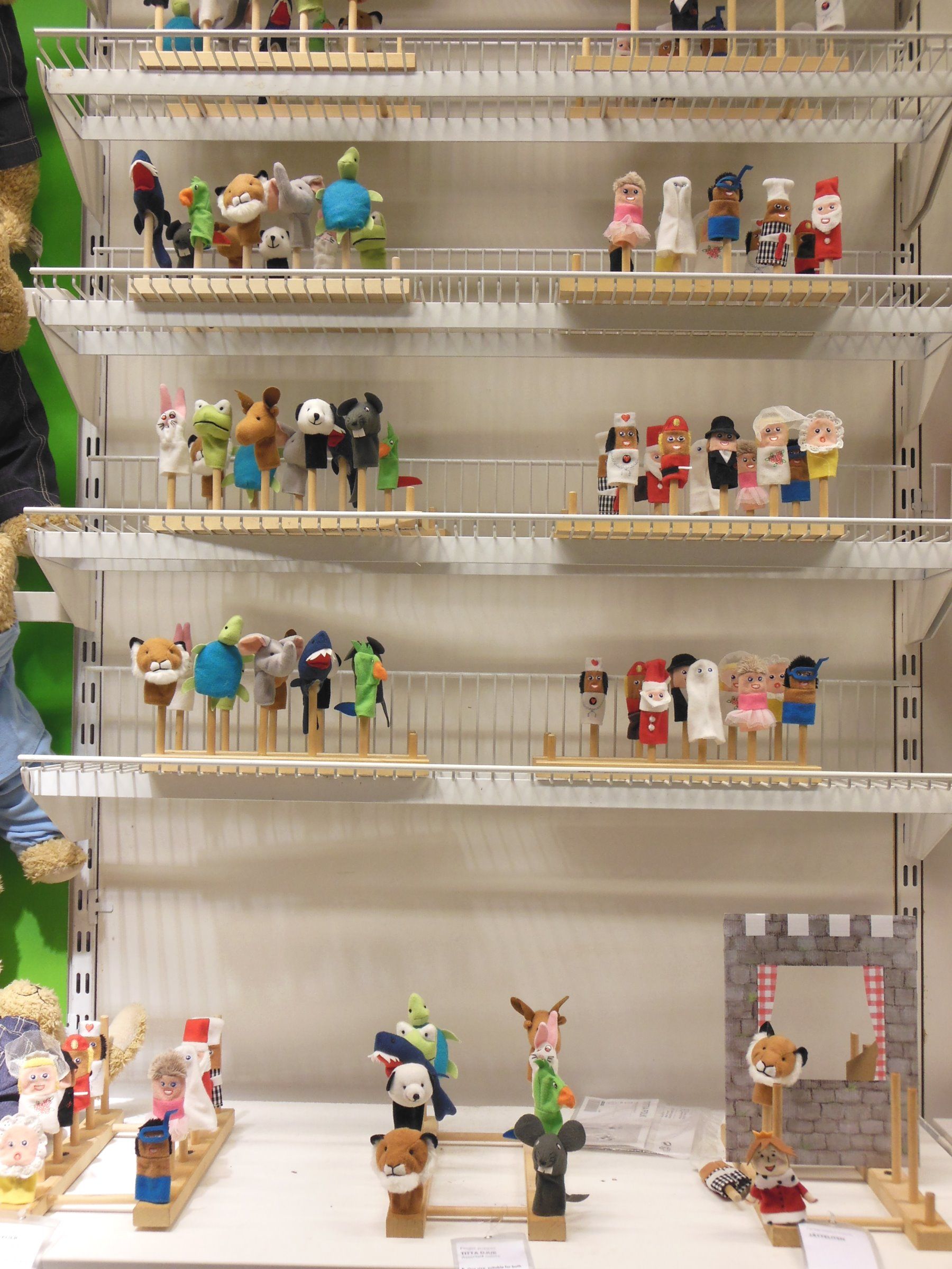 Shelves have finger puppets on them grouped into categories. (ikea classroom)