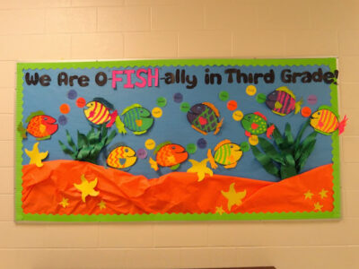 Sea-themed bulletin board idea that reads "we are o-fish-ally in third grade." fish scattered around the background