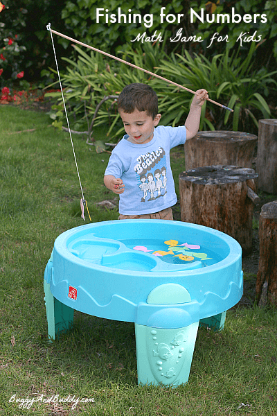 boy fishing with a toy fishing rod in a baby pool
