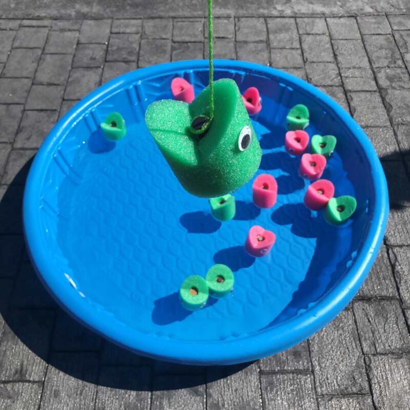 A kiddie pool is filled with fish made from pool noodles.