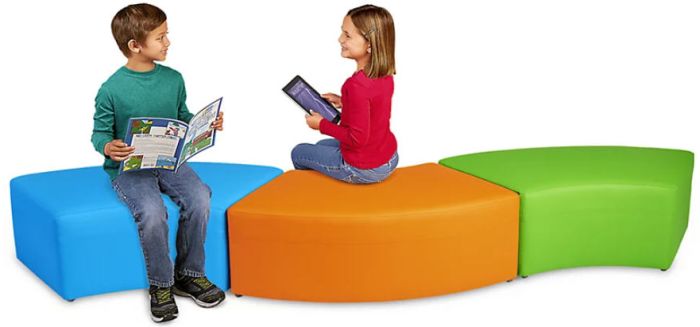 Students sitting on curved colorful cushions