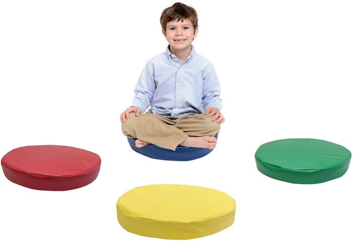 Child sitting on one of four colorful Kindermat round floor cushions (Flexible Seating Options)