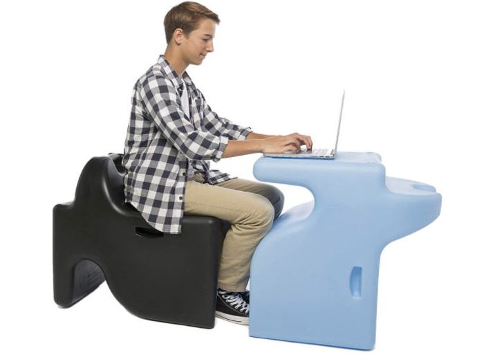 Student sitting at one Vidget 3-in-1 desk chair while using another as a desk