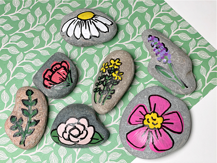 Rocks with colorfully painted flower designs
