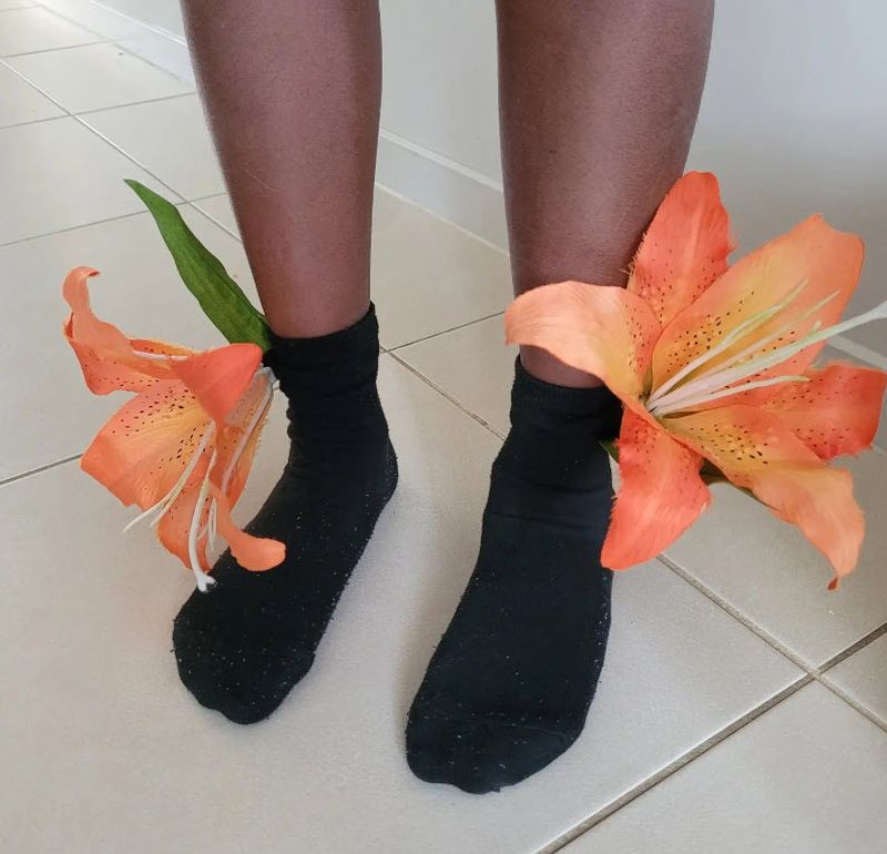 Black ankle socks with large artificial tiger lilies sewed to them