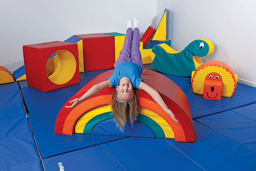 Kid laying on play structure made of foam