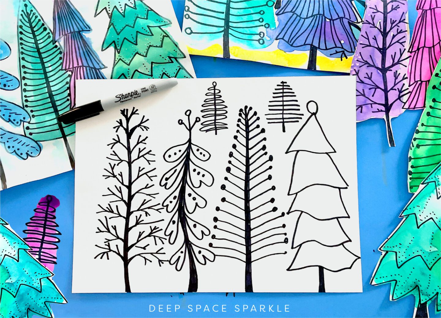 A white piece of paper has the outline of several different style trees in black. Paintings with trees colored using watercolor are shown in the background (third grade art projects)