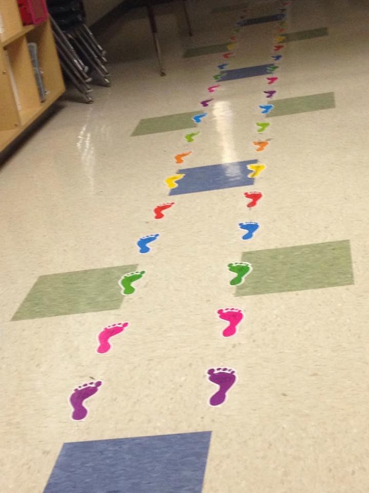 footprint stickers on a hallway for students to step on while lining up
