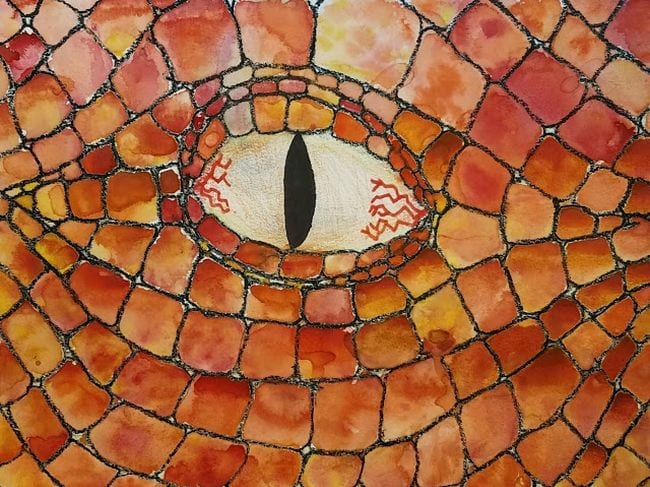 Close-up of a dragon eye made with watercolor resist and colored pencil