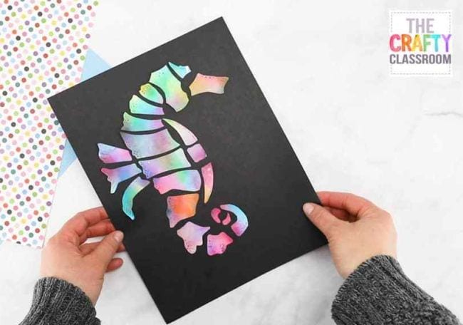 Seahorse in pastel colors pasted on black construction paper