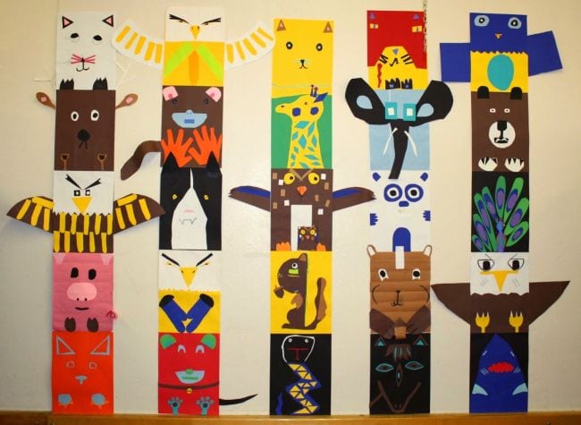 Colorful construction paper totem poles showing a variety of animals