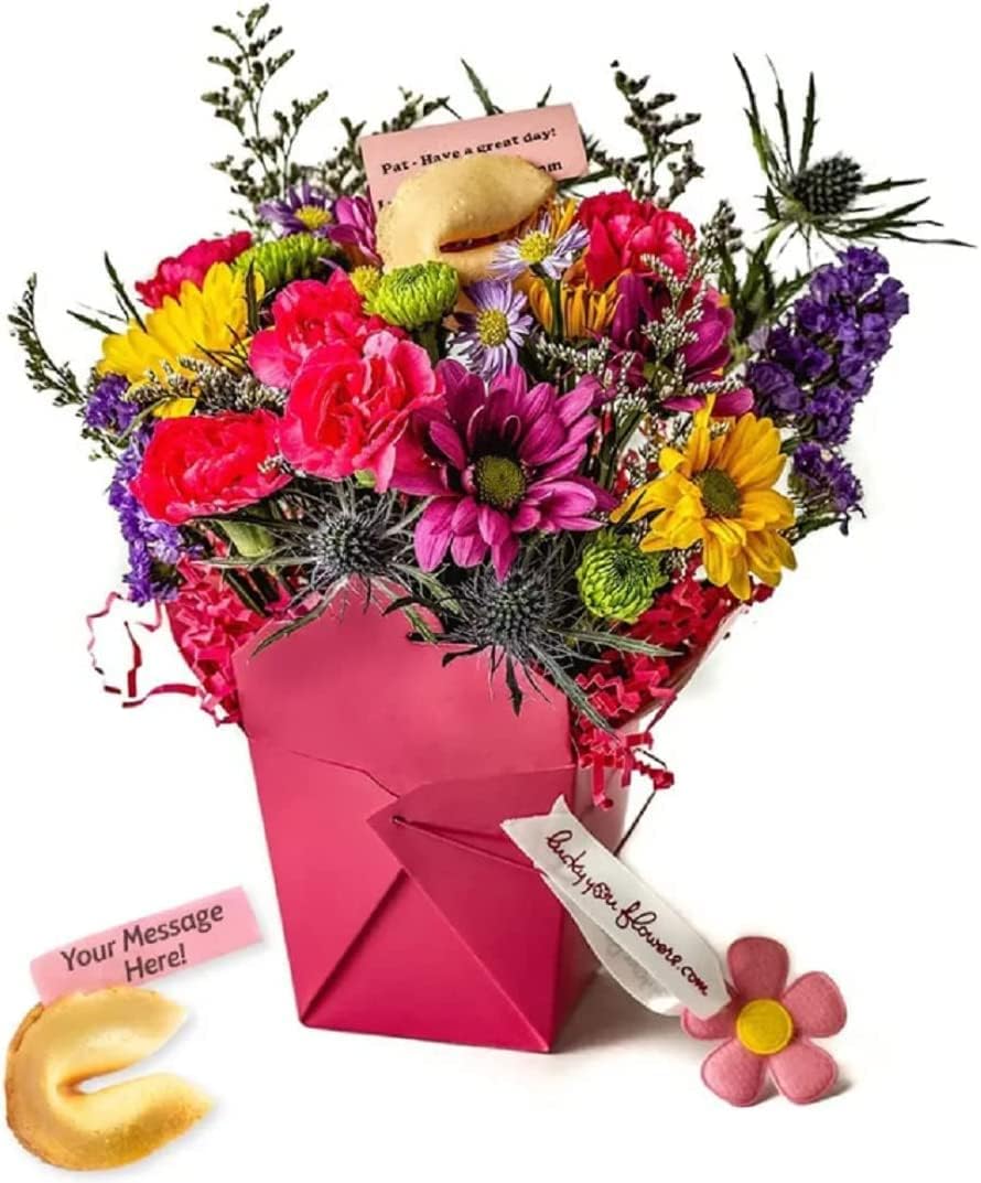 Fresh flowers arranged in a hot pink takeout food box