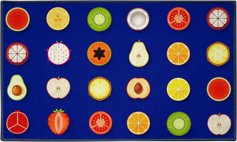 A blue rug has different fruit slices making up the 23 seats.
