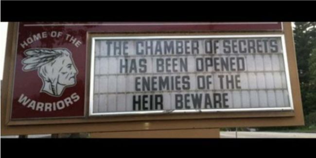 School marquee reading "The Chamber of Secrets has been opened. Enemies of the heir beware."