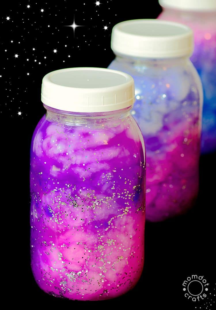 Space activities for kids can be made in jars like these galaxies that have been created inside clear jars. They are purple inside with sparkles.