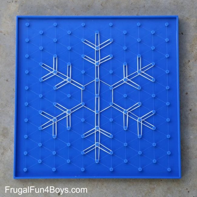 A blue geoboard with a white snowflake in the center as an example of indoor recess games and activities