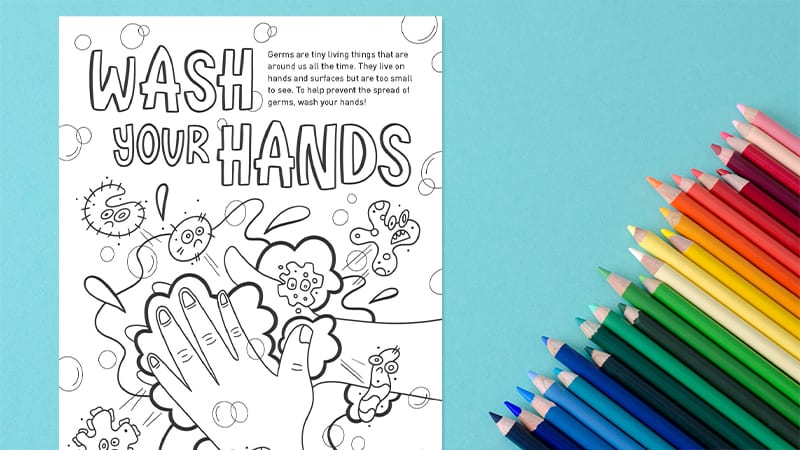 Coloring page about washing hands with colored pencils next to it